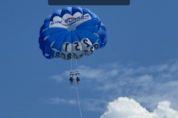 Parasailing Over Orange Beach With Sky Surfer